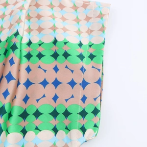 Close-up of geometric pattern on satin shirt with smooth texture and neat stitching
