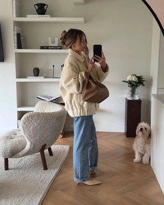 Mirror selfie showing an off-white sherpa jacket with high-waist straight-leg jeans
