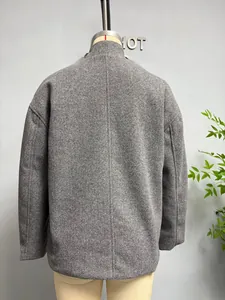 Detail of grey wool coat back with drop shoulder seams and textured grain fabric