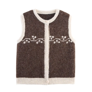 Detail of the vintage floral jacquard pattern and soft knitted texture on brown vest