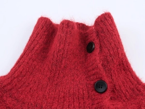 Close-up of dark red cable knit sweater featuring side buttons on a mock neckline