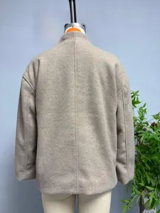 Detailed back view of oatmeal wool blend coat featuring raglan sleeves and sharp center seam