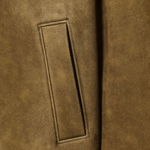 Women suede jacket in dark olive showing premium fabric texture and welt pocket detail