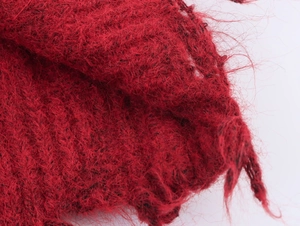 Detailed macro view of dark red mohair knit fabric showing soft plush fiber texture