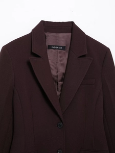 Detail of burgundy suit jacket with notched lapel and high-quality fabric texture