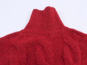 Detailed macro shot of dark red chunky knit sweater neck with soft wool texture