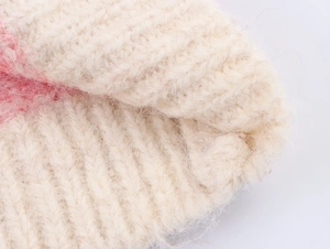 Close-up of beige jacquard knit vest showing soft mohair texture and ribbing detail