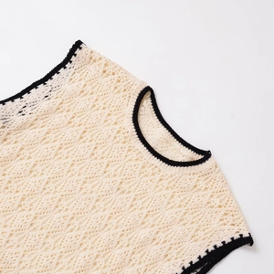Chic cream openwork knit vest with contrasting black trim and diamond texture