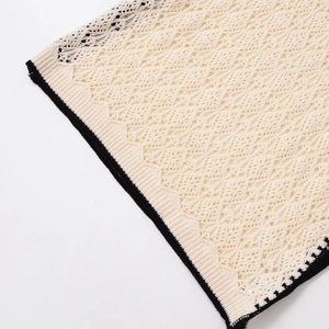 Women's sleeveless knit vest featuring cream crochet hollow texture and black contrast edges