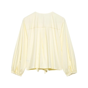 Detailed back view of a light yellow long-sleeve blouse with stylish pleated back design