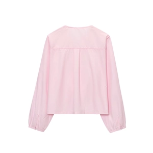 Detailed back view of pink long-sleeved shirt with pleats and pleated cuffs