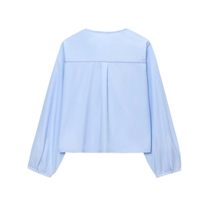 Detailed back view of a light blue shirt with a decorative pleat and horizontal stitching