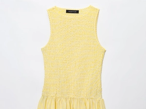 Detail of yellow gingham sleeveless top showing smocked texture and round neckline