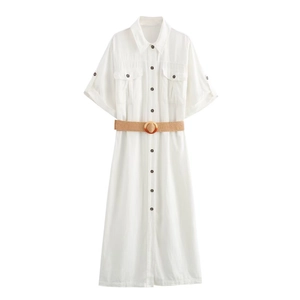 Detail of white cotton midi shirt dress featuring dual chest pockets and a straw belt
