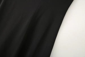 Macro detail of the high-quality black woven fabric texture and precision sewing line