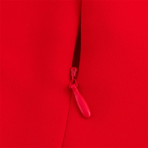 Detailed close-up of a high-quality invisible zipper on a red halter midi dress