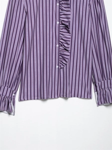 Detail of ruffle trim and button cuffs on purple striped long sleeve blouse