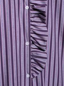 Detail of purple striped fabric with ruffles and translucent buttons on the shirt