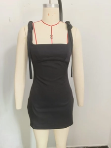 Detail of square neck and shoulder ties on black bodycon mini dress displayed on mannequin