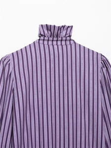 Detail view of ruffle high neck collar and purple striped fabric on a long sleeve shirt