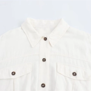White cotton linen midi shirt dress with buttoned chest pockets and classic lapel