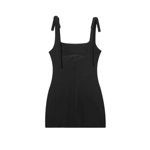 Detail of elegant black mini dress featuring square neck and shoulder bow tie straps