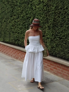Detail of white strapless ruffle top and high waist maxi skirt in breathable fabric