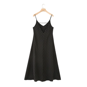 Detail of a vintage black and white polka dot sleeveless maxi dress with thin straps
