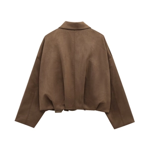 Macro detail of dark brown suede bomber jacket showing back seam and textured fabric