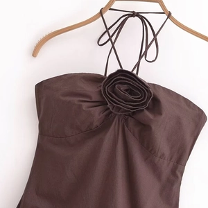 Elegant dark brown halter top featuring a 3D floral decoration and textured cotton fabric