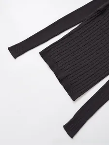Detail of dark grey striped knit sweater showing textured cable knit and ribbed hemline