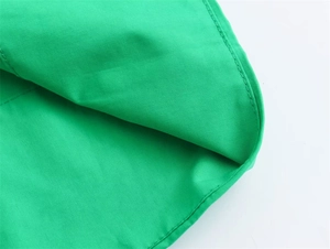 Detaillierte Makroansicht der Nähte und des Saums an einem hellgrünen A-Linien-Hemdkleid