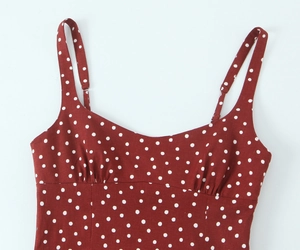 Detail of red polka dot midi dress showing adjustable straps and pleated sweetheart neckline