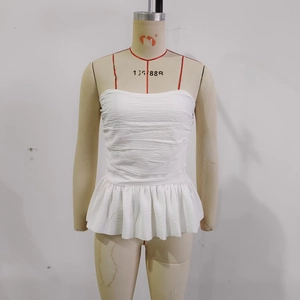 Elegant white pleated camisole with thin straps and ruffled hemline in textured fabric