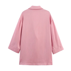 Back view of pink blazer jacket with vertical pleated texture and tailored cuffs