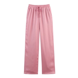 Detail of pink wide leg trousers showing elastic drawstring waist and vertical ribbed texture