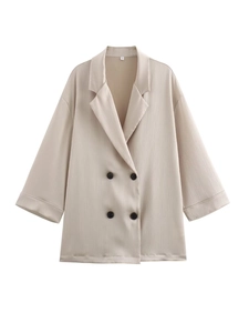 Close-up of apricot double-breasted blazer showing vertical pleated texture and size S tag