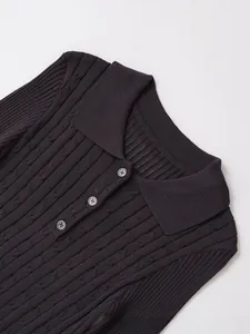 Detail shot of classic cable knit texture and buttoned polo collar on dark brown sweater