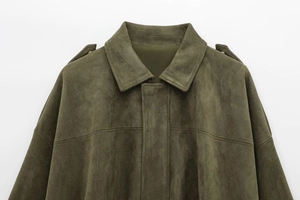 Detailed close-up of dark olive green faux suede bomber jacket with shoulder epaulettes