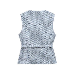 Detail of the back of a blue and white tweed vest showing woven texture and waist belt