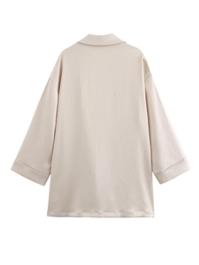 Back view of beige oversized blazer featuring vertical pleated texture and lapel