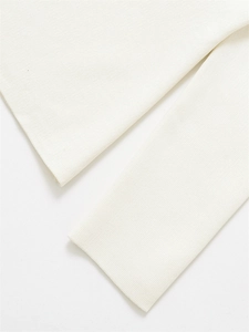 Detailed close-up showing the fine knit texture and cuff stitching of this white V-neck sweater