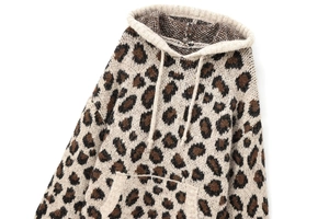Detail of leopard print knit hoodie featuring soft textured fabric and kangaroo pocket