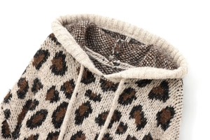 Detail of leopard print knitted hoodie showing texture, ribbed collar, and drawstring