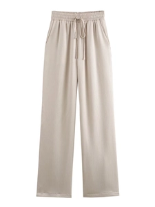Detail of beige pleated wide-leg trousers with adjustable drawstring elastic waist