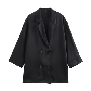 Detail of black double-breasted blazer with satin texture and vertical grain fabric