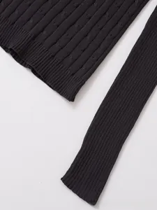 Detail view showing intricate cable knit texture and ribbed cuffs on striped sweater