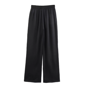 Detail of black wide-leg trousers with elastic waistband and smooth satin texture