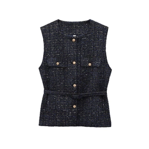 Close-up of dark blue tweed vest texture with gold buttons and matching waist belt