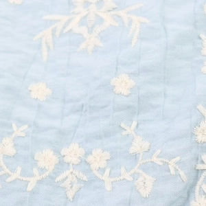 Light blue summer camisole featuring intricate white floral embroidery details